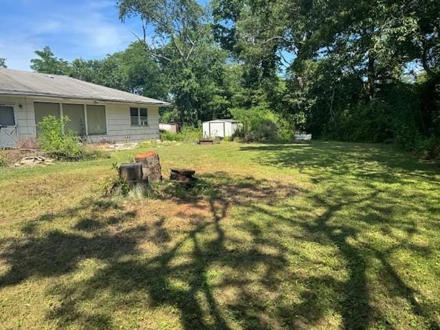 180 Baiting Place Rd, Farmingdale, NY 11735 - view of green lawn with a shed