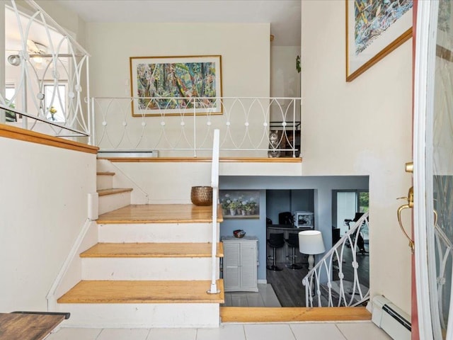 25 Amapola Ln, Kings Park, NY 11754 - stairway with a baseboard heating unit, tile patterned floors, and plenty of natural light