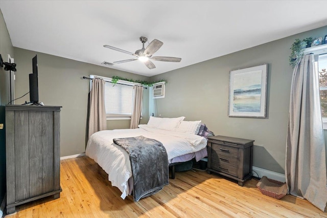 25 Amapola Ln, Kings Park, NY 11754 - bedroom with multiple windows, light wood finished floors, a wall mounted air conditioner, and a ceiling fan