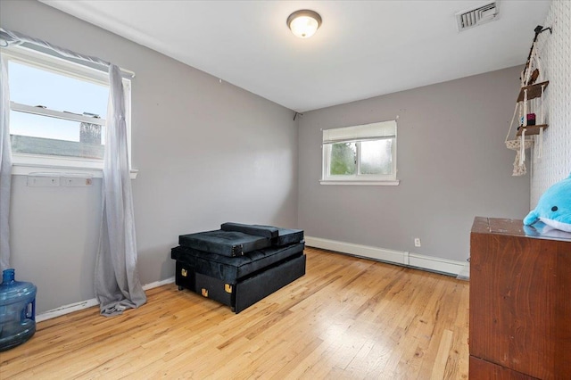 25 Amapola Ln, Kings Park, NY 11754 - bedroom with a baseboard radiator and wood-type flooring