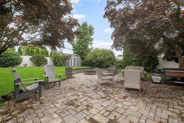 25 Amapola Ln, Kings Park, NY 11754 - fenced backyard featuring a fire pit, a storage unit, and a patio