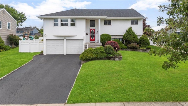 25 Amapola Ln, Kings Park, NY 11754 - bi-level home featuring asphalt driveway, an attached garage, a shingled roof, and stucco siding