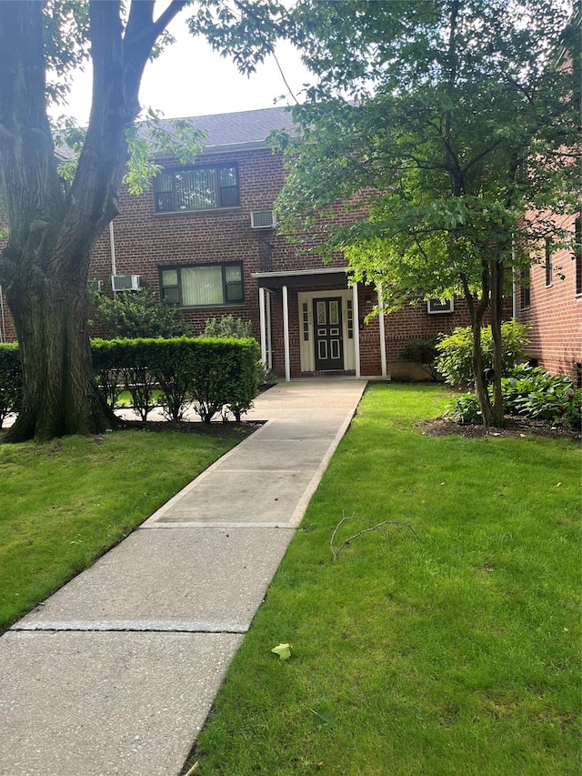 90-32 153rd Ave Unit 0029, Howard Beach, NY 11414 - view of front of home with brick siding and a front lawn