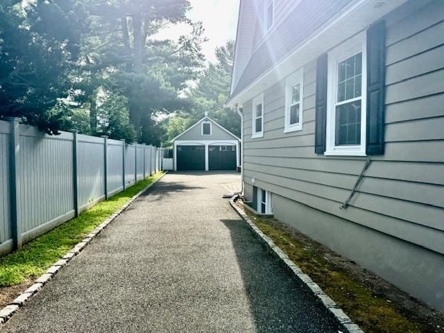 987 E Prospect St, Woodmere, NY 11598 - view of side of property featuring an outdoor structure and a garage