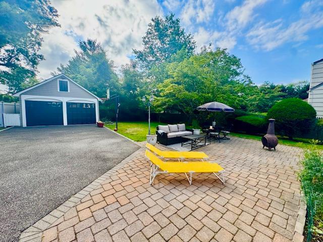 987 E Prospect St, Woodmere, NY 11598 - view of patio featuring an outdoor living space and an outbuilding