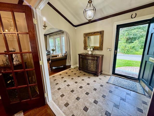 987 E Prospect St, Woodmere, NY 11598 - entryway with arched walkways, crown molding, a chandelier, and vaulted ceiling