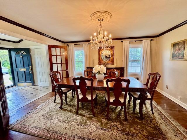 987 E Prospect St, Woodmere, NY 11598 - dining space with ornamental molding, wood finished floors, a chandelier, and plenty of natural light
