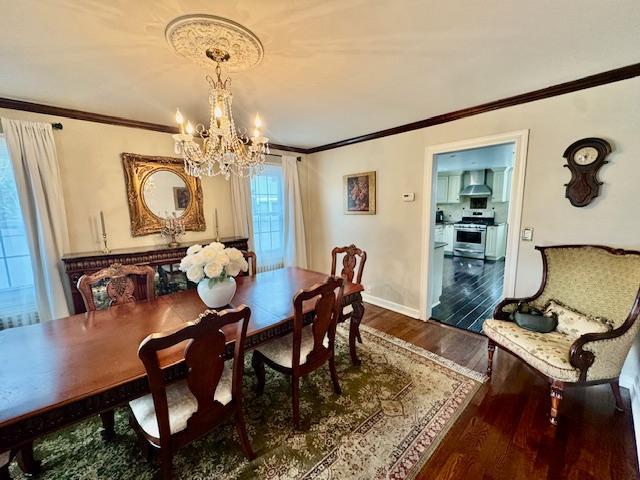 987 E Prospect St, Woodmere, NY 11598 - dining space featuring a chandelier, dark wood-type flooring, and ornamental molding