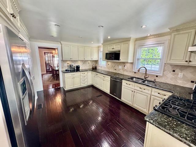 987 E Prospect St, Woodmere, NY 11598 - kitchen featuring stainless steel appliances, cream cabinetry, dark wood finished floors, dark stone countertops, and recessed lighting