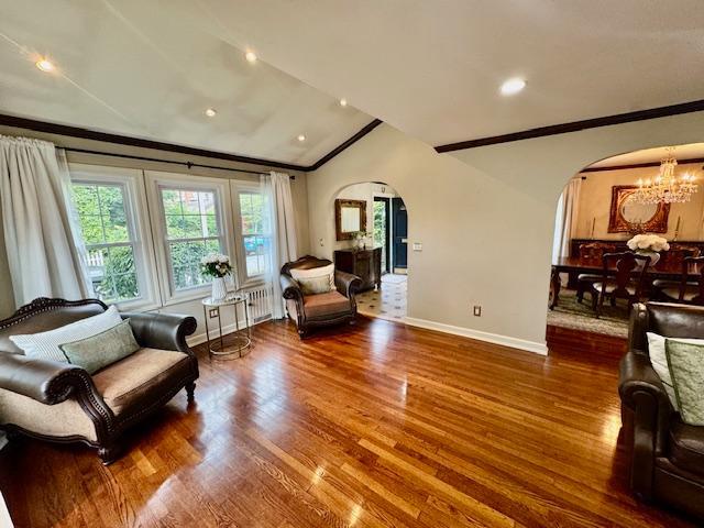 987 E Prospect St, Woodmere, NY 11598 - sitting room with arched walkways, lofted ceiling, wood finished floors, crown molding, and a chandelier
