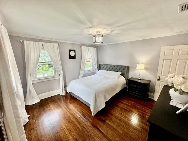 987 E Prospect St, Woodmere, NY 11598 - bedroom with wood finished floors and ornamental molding
