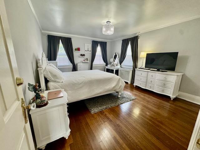 987 E Prospect St, Woodmere, NY 11598 - bedroom featuring dark wood-type flooring and crown molding