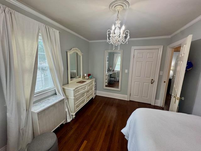 987 E Prospect St, Woodmere, NY 11598 - bedroom featuring a chandelier, dark wood-style floors, and crown molding