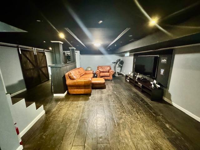 987 E Prospect St, Woodmere, NY 11598 - cinema featuring a barn door and hardwood / wood-style flooring