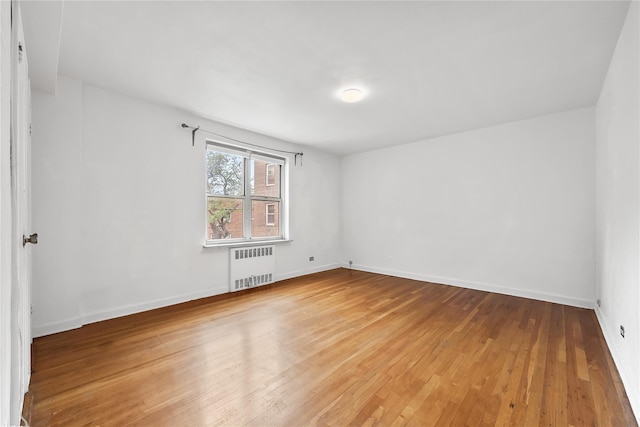 147-25 38th Ave Unit F26, Flushing, NY 11354 - unfurnished room featuring radiator heating unit and light wood finished floors