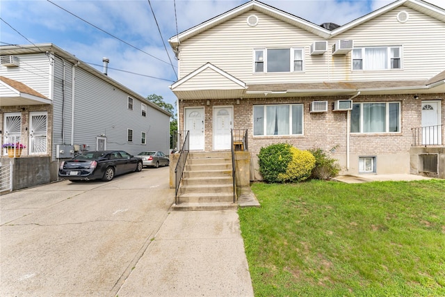 1051 Bay 32nd St, Bayswater, NY 11691 - traditional-style home featuring brick siding, a front yard, and a wall unit AC