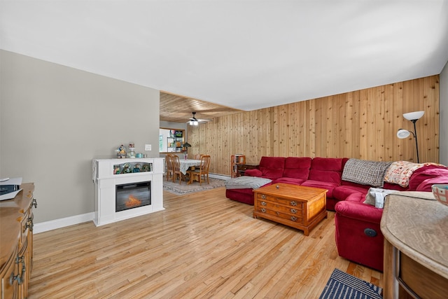 130 Marcus Rd, Ellenville, NY 12428 - living area featuring light wood-style flooring, wooden walls, ceiling fan, and baseboard heating