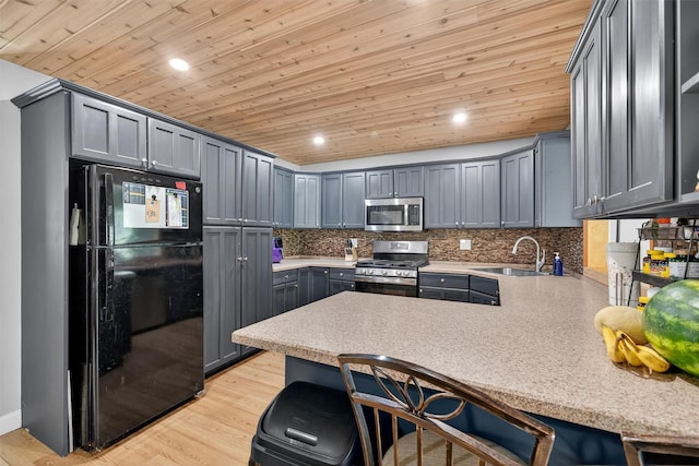130 Marcus Rd, Ellenville, NY 12428 - kitchen with appliances with stainless steel finishes, a peninsula, wood ceiling, light countertops, and backsplash