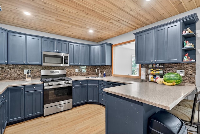 130 Marcus Rd, Ellenville, NY 12428 - kitchen featuring appliances with stainless steel finishes, a breakfast bar area, a peninsula, open shelves, and recessed lighting