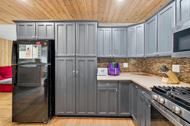 130 Marcus Rd, Ellenville, NY 12428 - kitchen with appliances with stainless steel finishes, gray cabinets, light countertops, light wood-style floors, and tasteful backsplash