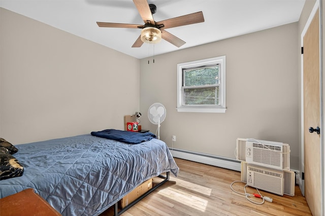 130 Marcus Rd, Ellenville, NY 12428 - bedroom with a baseboard radiator, wood finished floors, a wall mounted AC, and ceiling fan