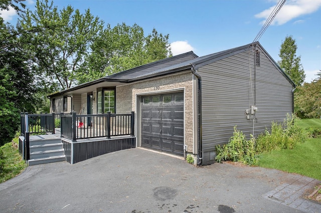 130 Marcus Rd, Ellenville, NY 12428 - view of home's exterior featuring covered porch, an attached garage, and driveway