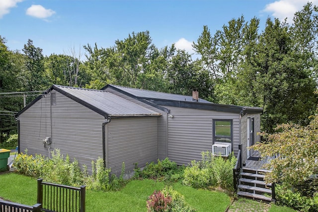 130 Marcus Rd, Ellenville, NY 12428 - view of side of property with a deck, a metal roof, a lawn, cooling unit, and a chimney