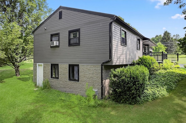 130 Marcus Rd, Ellenville, NY 12428 - view of side of property featuring stone siding, a lawn, a wooden deck, and cooling unit