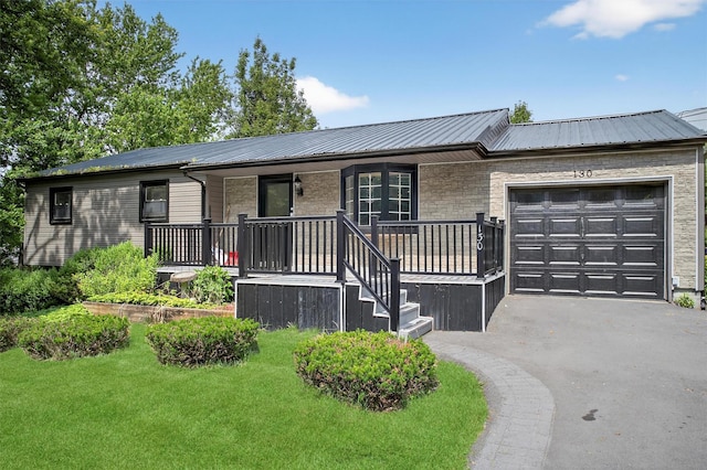 130 Marcus Rd, Ellenville, NY 12428 - single story home with a porch, an attached garage, a metal roof, and asphalt driveway