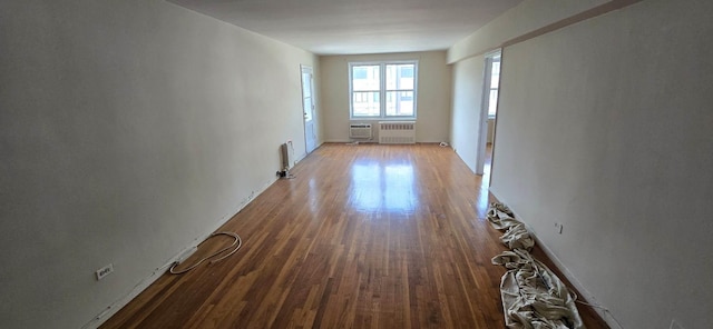 24120 Northern Blvd Unit 4C, Douglaston, NY 11362 - corridor with radiator heating unit and wood finished floors