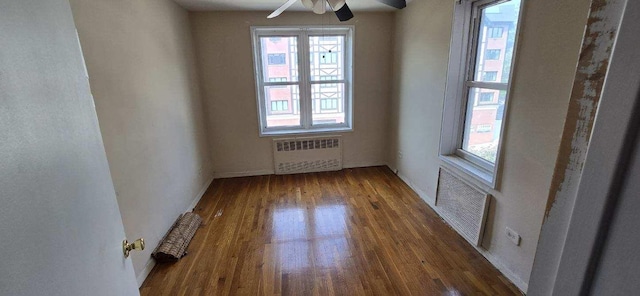 24120 Northern Blvd Unit 4C, Douglaston, NY 11362 - empty room featuring radiator heating unit, a ceiling fan, and wood finished floors