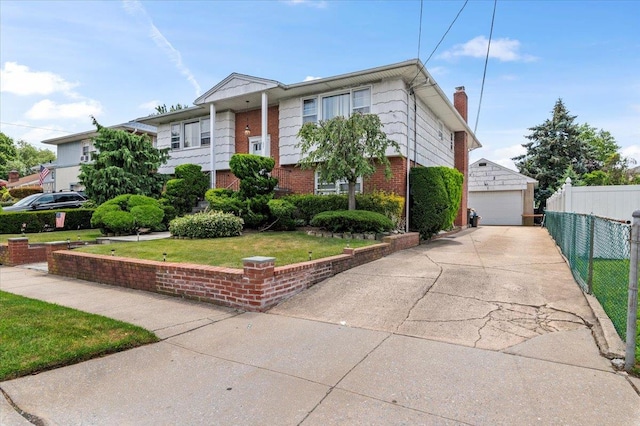 227 Randall Ave, Lawrence, NY 11559 - bi-level home with brick siding, a detached garage, an outdoor structure, and a chimney
