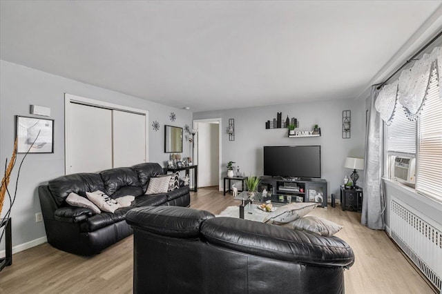 227 Randall Ave, Lawrence, NY 11559 - living area with radiator heating unit, light wood-style flooring, and cooling unit