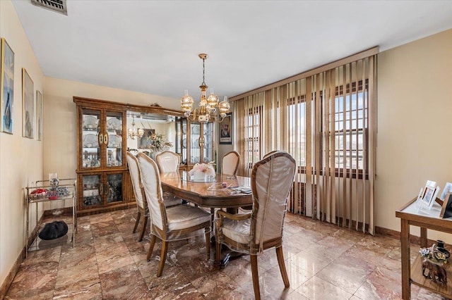 227 Randall Ave, Lawrence, NY 11559 - dining room with a chandelier and baseboards