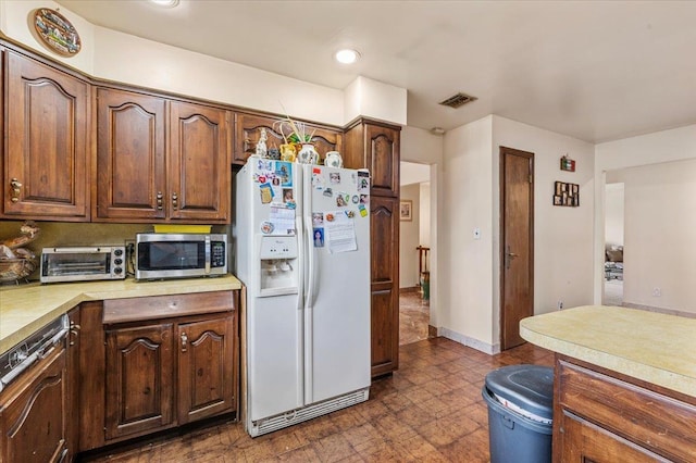 227 Randall Ave, Lawrence, NY 11559 - kitchen with white fridge with ice dispenser, light countertops, stainless steel microwave, dishwasher, and recessed lighting