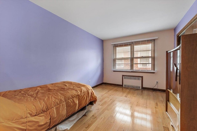 227 Randall Ave, Lawrence, NY 11559 - bedroom featuring radiator heating unit and light wood-type flooring