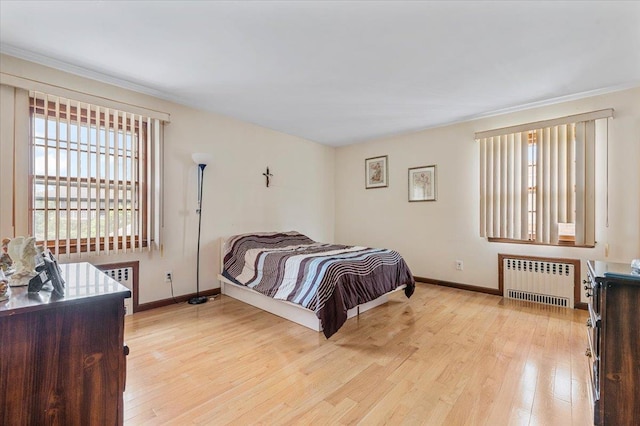 227 Randall Ave, Lawrence, NY 11559 - bedroom featuring radiator, light wood-style flooring, and crown molding