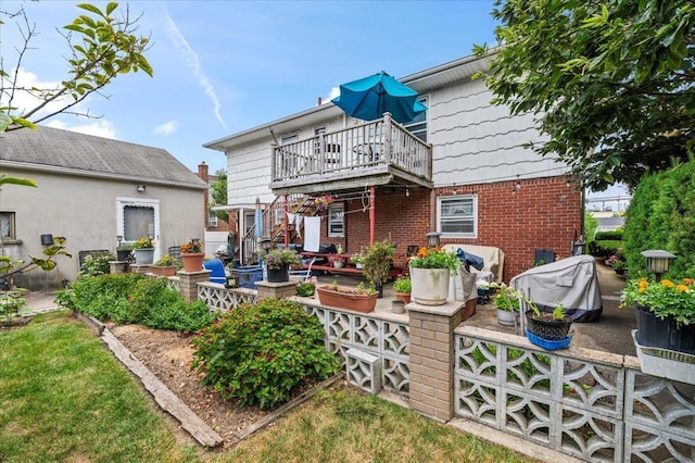 227 Randall Ave, Lawrence, NY 11559 - rear view of house with brick siding, a patio area, and a deck