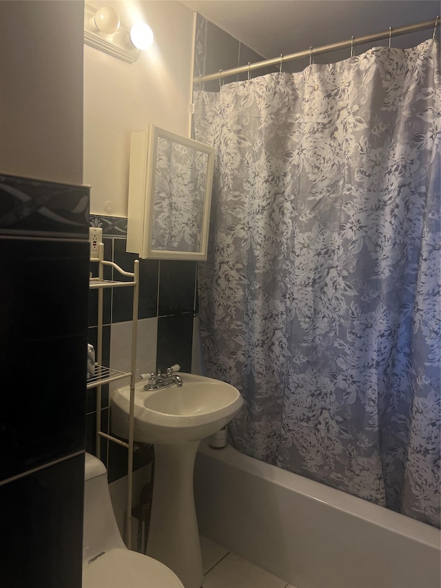 264-31 Langston Ave Fl 2Nd, Glen Oaks, NY 11004 - full bath with shower / bath combo with shower curtain, tile walls, and a wainscoted wall