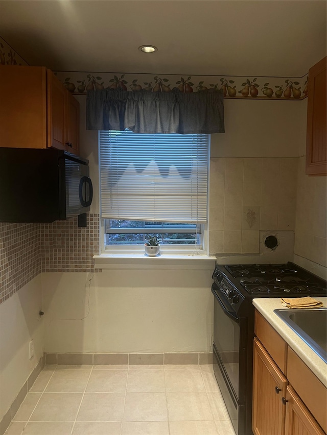 264-31 Langston Ave Fl 2Nd, Glen Oaks, NY 11004 - kitchen with black appliances, light tile patterned floors, decorative backsplash, light countertops, and recessed lighting