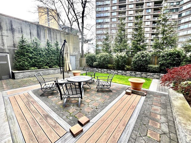 21019 26th Avenue Tl, Bayside, NY 11360 - wooden deck featuring a fenced backyard, outdoor dining space, and a patio