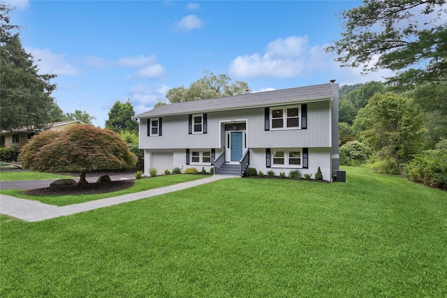 297 Farm To Market Rd, Brewster, NY 10509 - raised ranch with a garage, a chimney, a front lawn, driveway, and brick siding