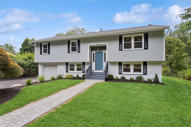 297 Farm To Market Rd, Brewster, NY 10509 - bi-level home with brick siding, a garage, and a front yard