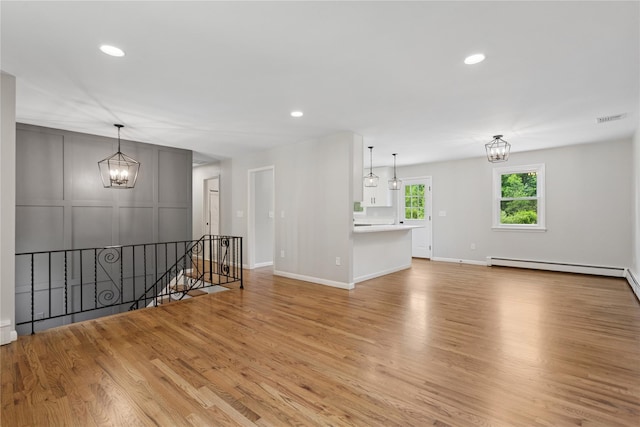 297 Farm To Market Rd, Brewster, NY 10509 - spare room with a chandelier, light wood finished floors, baseboard heating, and recessed lighting