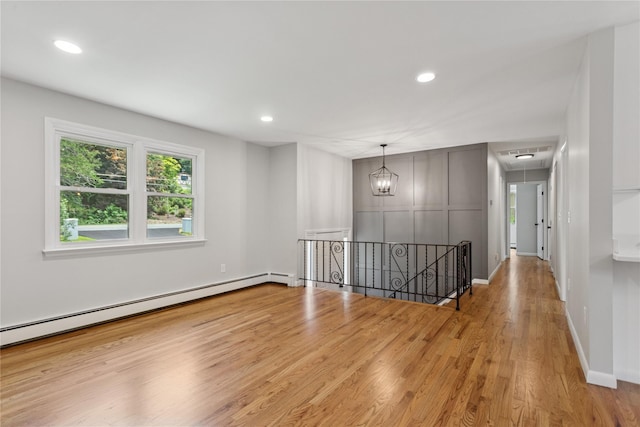 297 Farm To Market Rd, Brewster, NY 10509 - empty room with attic access, a baseboard heating unit, wood finished floors, and recessed lighting