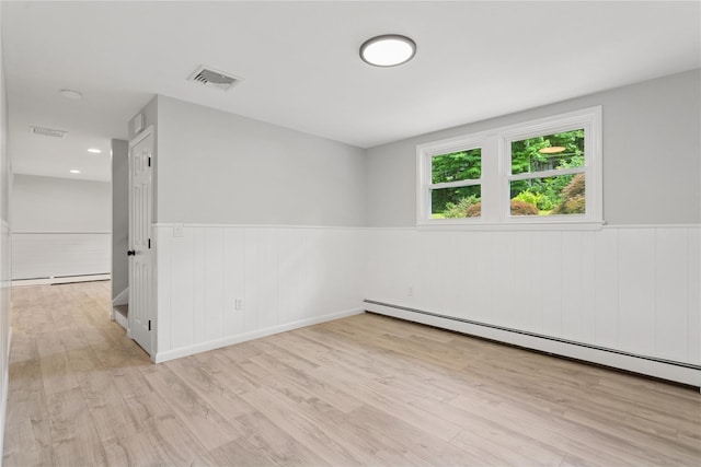297 Farm To Market Rd, Brewster, NY 10509 - empty room featuring a baseboard heating unit, a wainscoted wall, and wood finished floors