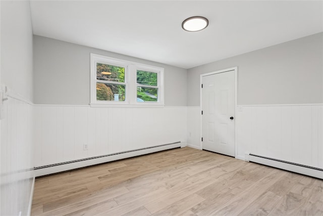 297 Farm To Market Rd, Brewster, NY 10509 - unfurnished room with baseboard heating, a wainscoted wall, and wood finished floors