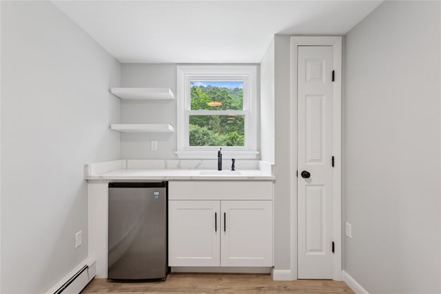 297 Farm To Market Rd, Brewster, NY 10509 - bar featuring baseboard heating, light wood-type flooring, and refrigerator