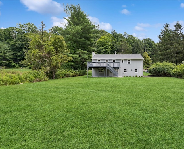 297 Farm To Market Rd, Brewster, NY 10509 - view of green lawn with stairway, a wooden deck, and a view of trees