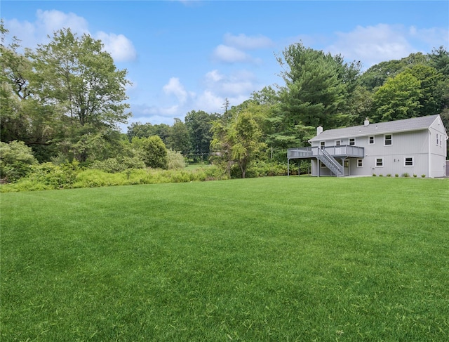 297 Farm To Market Rd, Brewster, NY 10509 - view of green lawn featuring stairway, a wooden deck, and a wooded view